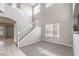 Bright foyer showcasing a staircase, tile and carpet flooring, and a plant for added style at 3731 Prairie Orchid Ave, North Las Vegas, NV 89081