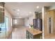 Open concept kitchen with olive cabinets, granite countertops and view into living room at 3731 Prairie Orchid Ave, North Las Vegas, NV 89081