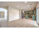 Open-concept kitchen with olive cabinets, stainless steel appliances, an island, and a view to living area at 3731 Prairie Orchid Ave, North Las Vegas, NV 89081