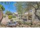 Expansive backyard with a patio, pergola, fire pit, and lush landscaping, perfect for outdoor entertaining at 3749 Climbing Rose St, Las Vegas, NV 89147