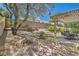 Picturesque backyard featuring a shaded patio, mature trees, and stone pavers, ideal for relaxation and gatherings at 3749 Climbing Rose St, Las Vegas, NV 89147