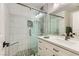 Elegant bathroom featuring a glass-enclosed shower with modern tile work and a white vanity with a countertop at 3749 Climbing Rose St, Las Vegas, NV 89147