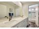 Bright bathroom featuring a double sink vanity with modern fixtures and a separate shower and tub combo at 3749 Climbing Rose St, Las Vegas, NV 89147