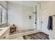 New bathroom with marble shower, pebble floor, window and new tile at 3749 Climbing Rose St, Las Vegas, NV 89147