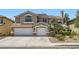 Charming two-story home featuring a three-car garage, arched windows and well-maintained landscaping at 3749 Climbing Rose St, Las Vegas, NV 89147