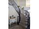 Grand foyer featuring a curved staircase with decorative iron railings and a stylish console table at 3749 Climbing Rose St, Las Vegas, NV 89147