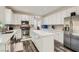 Modern kitchen with white cabinets, stainless steel appliances, subway tile backsplash and a center island at 3749 Climbing Rose St, Las Vegas, NV 89147