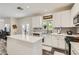 Beautifully renovated kitchen featuring an island, white cabinets, tile backsplash and stainless appliances at 3749 Climbing Rose St, Las Vegas, NV 89147