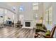 Open-concept living area with soaring ceilings, lots of windows, fireplace, and stylish wood-look floors at 3749 Climbing Rose St, Las Vegas, NV 89147