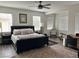 Spacious main bedroom with a ceiling fan, multiple windows, and neutral decor providing a peaceful retreat at 3749 Climbing Rose St, Las Vegas, NV 89147