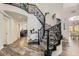 Elegant staircase showcasing wrought iron railings, carpeted steps and wood flooring at 3749 Climbing Rose St, Las Vegas, NV 89147