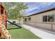 Charming backyard with lush synthetic grass, play structure, and covered patio area perfect for relaxing at 3760 Candytuft Ridge Ave, North Las Vegas, NV 89081