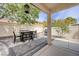 Covered backyard patio features stone flooring and a barbecue grill at 3760 Candytuft Ridge Ave, North Las Vegas, NV 89081