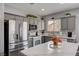 Charming kitchen with gray cabinets, stainless steel appliances, and a bright window overlooking the backyard at 3760 Candytuft Ridge Ave, North Las Vegas, NV 89081