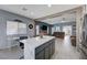 Open concept kitchen with a large island, gray cabinets, and views to the living room and breakfast nook at 3760 Candytuft Ridge Ave, North Las Vegas, NV 89081