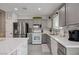 Bright kitchen with stainless steel appliances, gray cabinets, and a subway tile backsplash at 3760 Candytuft Ridge Ave, North Las Vegas, NV 89081