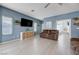 Spacious living room with neutral tile floors and comfortable seating at 3760 Candytuft Ridge Ave, North Las Vegas, NV 89081