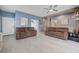 Bright living room with neutral tile flooring, ceiling fan, and comfortable sofas for relaxing at 3760 Candytuft Ridge Ave, North Las Vegas, NV 89081