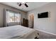 Bright main bedroom has a TV and window views at 3760 Candytuft Ridge Ave, North Las Vegas, NV 89081