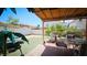 Backyard featuring a covered patio with outdoor seating, and a grassy area for activities at 3871 Sir Bret Ct, Las Vegas, NV 89104