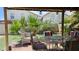 Backyard featuring a covered patio with outdoor seating, and a grassy area for activities at 3871 Sir Bret Ct, Las Vegas, NV 89104