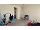 Bedroom with dirty carpet, featuring a chair and lots of clutter at 3871 Sir Bret Ct, Las Vegas, NV 89104
