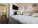 Comfortable bedroom with a large television mounted on the wall and a view into the hallway at 3871 Sir Bret Ct, Las Vegas, NV 89104