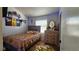Well-lit bedroom with wooden floors, featuring a bed and a dresser with mirror at 3871 Sir Bret Ct, Las Vegas, NV 89104