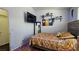 Bedroom featuring a mounted TV, decorative shelving, and blue LED accent lighting at 3871 Sir Bret Ct, Las Vegas, NV 89104