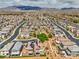 Grand aerial view showcasing a neighborhood with desert landscaping, solar panels, and mountain vistas at 415 Carsin Wayne Ct, North Las Vegas, NV 89031