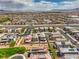 Extensive aerial view capturing a community with desert landscaping, solar panel installations, and distant mountains at 415 Carsin Wayne Ct, North Las Vegas, NV 89031