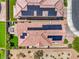 Bird's eye view of home featuring solar panels, small turf yard, desert landscaping, patio furniture, and hot tub at 415 Carsin Wayne Ct, North Las Vegas, NV 89031