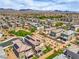 Panoramic aerial view showcasing houses with desert landscaping, solar panels, and mountain range in the distance at 415 Carsin Wayne Ct, North Las Vegas, NV 89031
