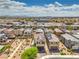 Expansive aerial view of a neighborhood featuring desert landscaping, solar panels, and stunning mountain views at 415 Carsin Wayne Ct, North Las Vegas, NV 89031