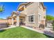 Spacious backyard with a covered patio, lush artificial grass, and privacy fencing at 415 Carsin Wayne Ct, North Las Vegas, NV 89031