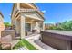 Inviting backyard features a covered patio, hot tub, and artificial turf, perfect for relaxation and entertainment at 415 Carsin Wayne Ct, North Las Vegas, NV 89031