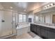 Bright bathroom featuring a shower, tub, and double vanity with granite counters at 415 Carsin Wayne Ct, North Las Vegas, NV 89031