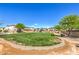 Expansive community park featuring lush green lawn, mature trees, and walking paths at 415 Carsin Wayne Ct, North Las Vegas, NV 89031