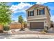 Lovely two-story home with a manicured front yard, beautiful landscape, and brick driveway at 415 Carsin Wayne Ct, North Las Vegas, NV 89031