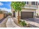 Inviting front entrance with a secure gate and a paved walkway leading to the door and garage at 415 Carsin Wayne Ct, North Las Vegas, NV 89031