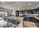 Contemporary kitchen features dark cabinetry, granite counters, a center island, and stainless appliances at 415 Carsin Wayne Ct, North Las Vegas, NV 89031