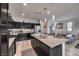 Kitchen featuring dark cabinets, stainless steel appliances, granite countertops, and a central island with seating at 415 Carsin Wayne Ct, North Las Vegas, NV 89031