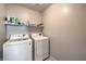 Functional laundry room featuring a modern washer and dryer set and convenient above-appliance shelving at 415 Carsin Wayne Ct, North Las Vegas, NV 89031