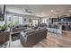 Open-concept living room with modern furniture, hardwood floors, and large windows for natural light at 415 Carsin Wayne Ct, North Las Vegas, NV 89031