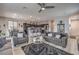 Open-concept living room flows into the kitchen, featuring modern decor, grey walls and luxury vinyl flooring at 415 Carsin Wayne Ct, North Las Vegas, NV 89031