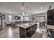 Open-concept living space with kitchen island, dining area and living room with a sliding door to the backyard at 415 Carsin Wayne Ct, North Las Vegas, NV 89031