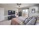 Comfortable bedroom with neutral decor, a sliding glass door to a balcony, and a ceiling fan at 415 Carsin Wayne Ct, North Las Vegas, NV 89031