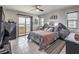 Main bedroom with black dressers, a ceiling fan and a sliding door to a private balcony with neighborhood views at 415 Carsin Wayne Ct, North Las Vegas, NV 89031