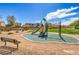 Community playground with climbing structure, slide, and bench seating for families to enjoy at 415 Carsin Wayne Ct, North Las Vegas, NV 89031