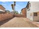 The backyard features a dirt lot, brick wall, and blue sky with sparse clouds at 4197 Tolkien Ave, Las Vegas, NV 89115